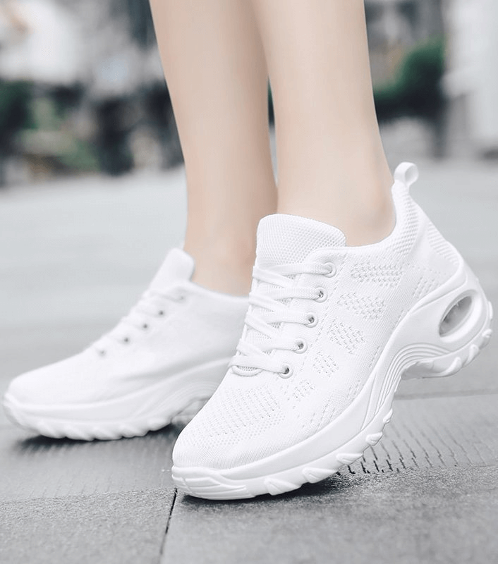 White breathable women's sneakers with mesh upper and EVA sole, perfect for active wear. Stylish and flexible design for optimal comfort.